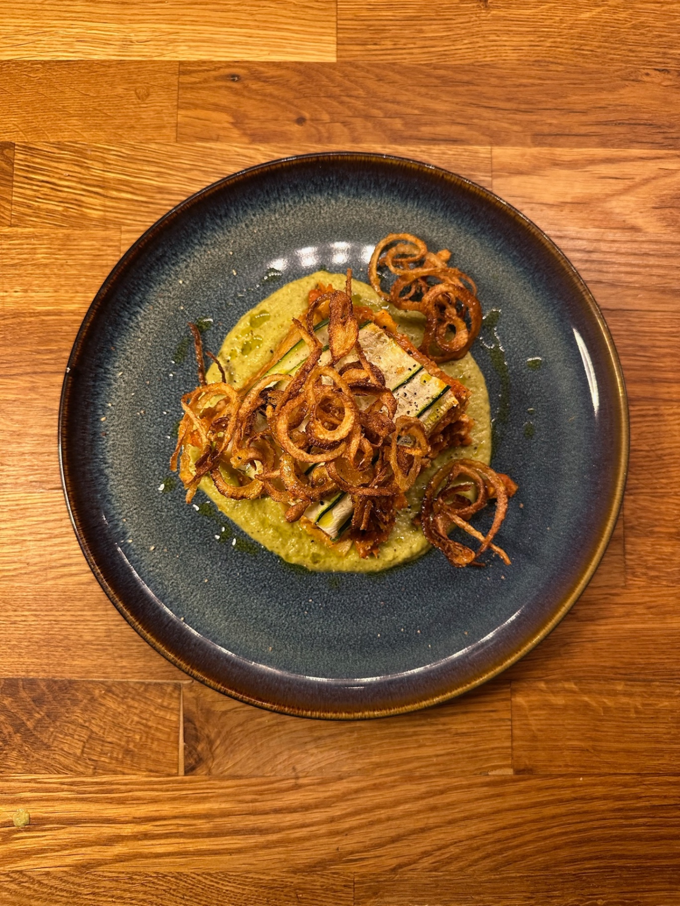 Zucchini and pepper terrine on basil pea purée, topped with crispy shallots