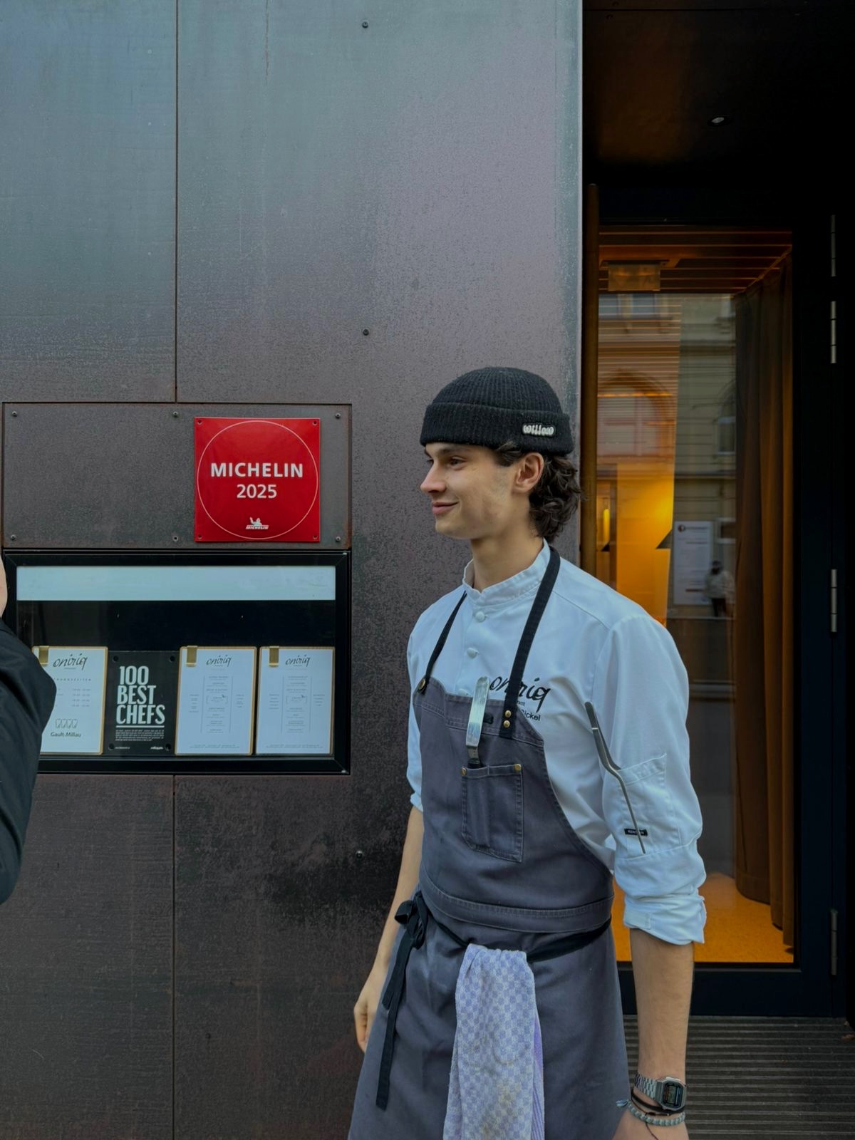 Leo in chef whites and apron outside the Michelin-listed restaurant where he cooks